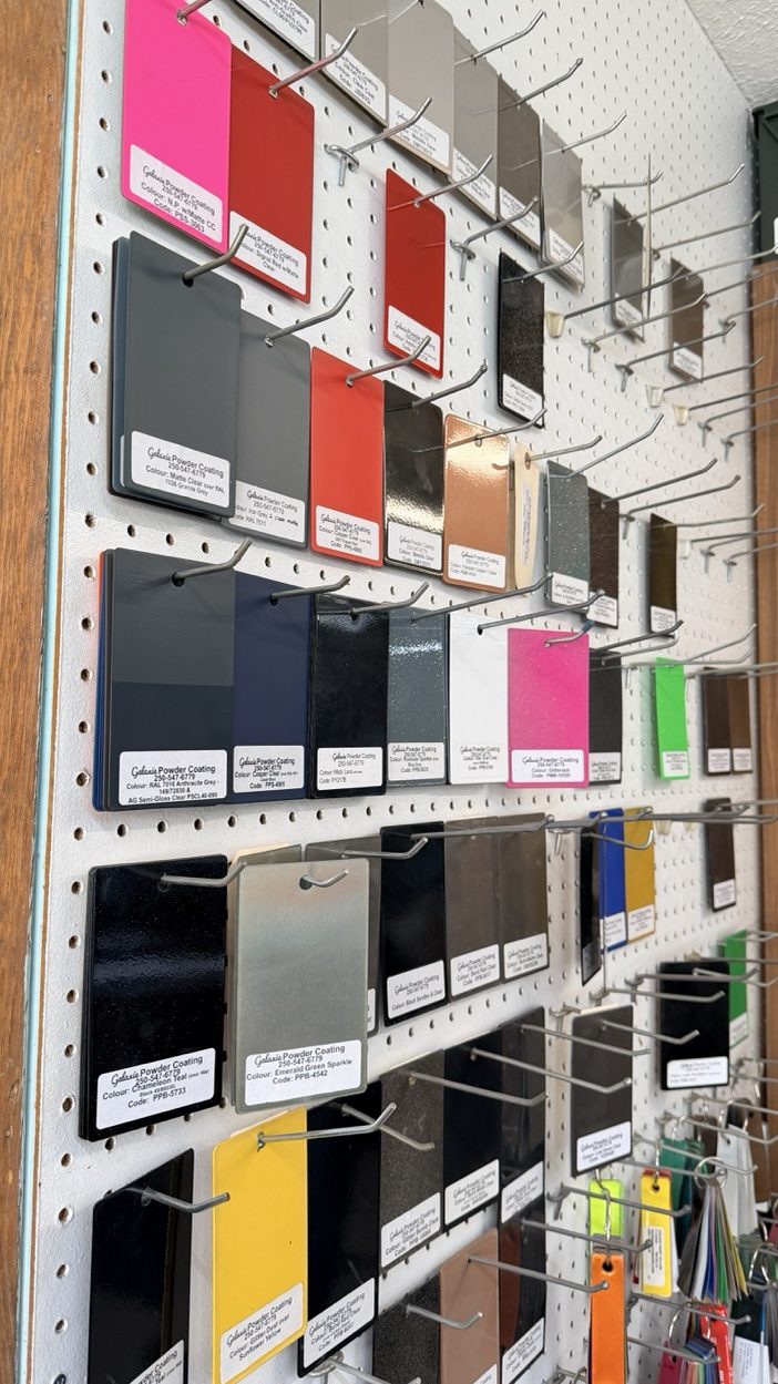 cerakote ceramic coating swatches displayed on the wall at galaxie powder coating in lumby bc