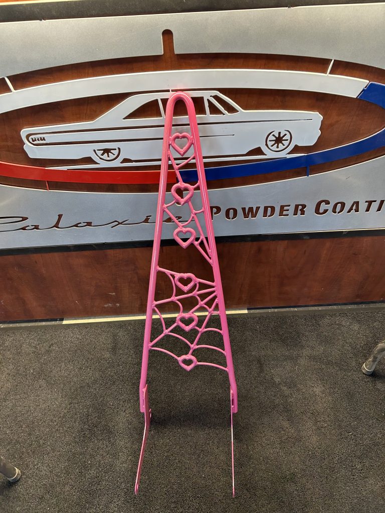 pink powder coated motorcycle sissy bar against galaxie powder coating logo