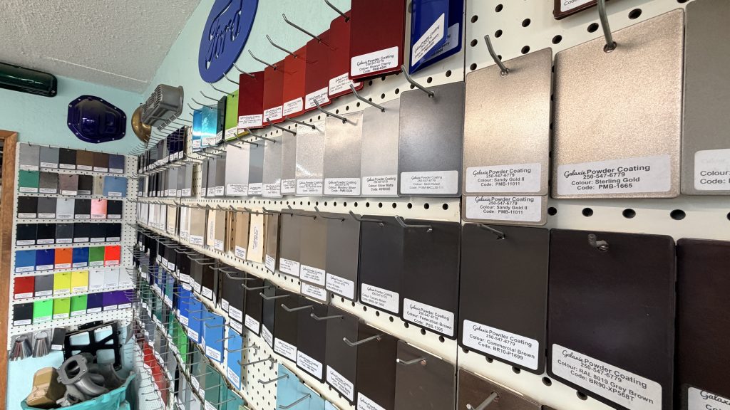 powder coating colour swatches hanging on wall at the galaxie powder coating shop